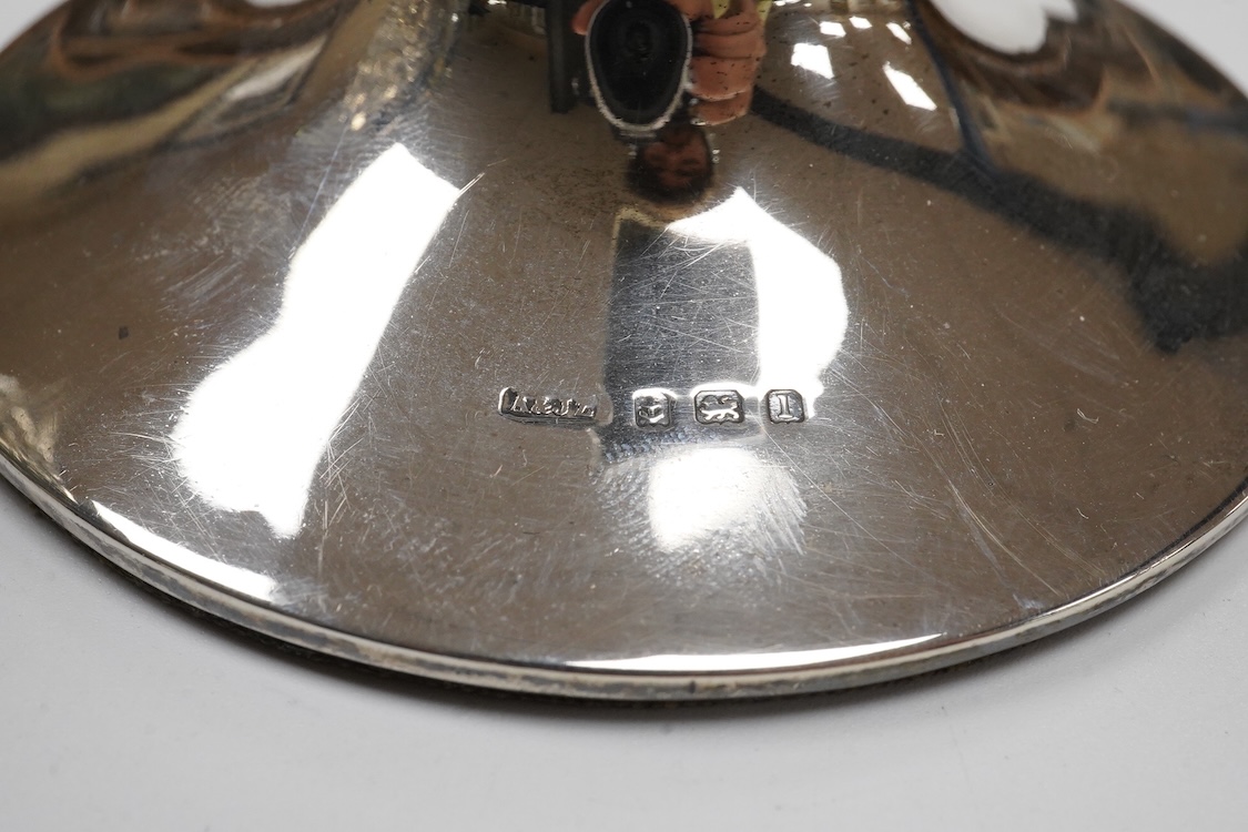 A late Victorian repousse silver oval tea caddy, by Nathan & Hayes, Chester, 1896, height 75mm, together with a George V silver mounted capstan inkwell.